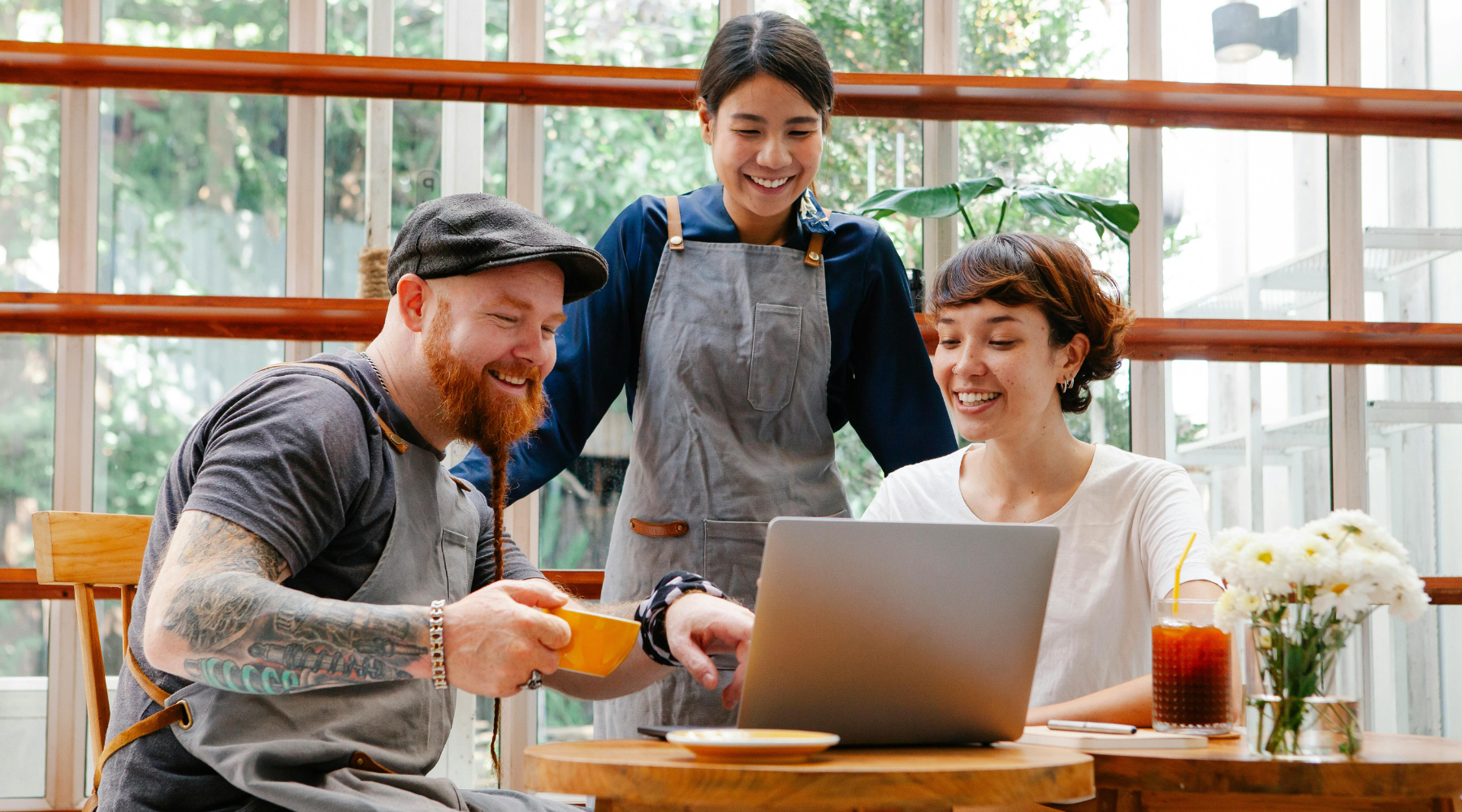 group-of-three-workers-staring-at-labtop-with-smile