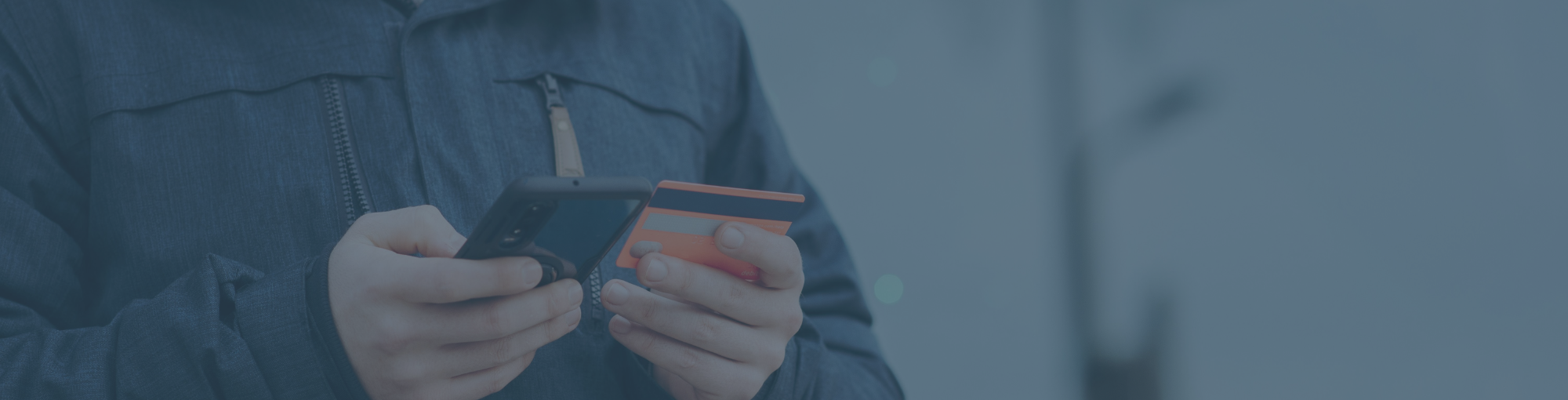 guy-outside-staring-at-phone-and-card