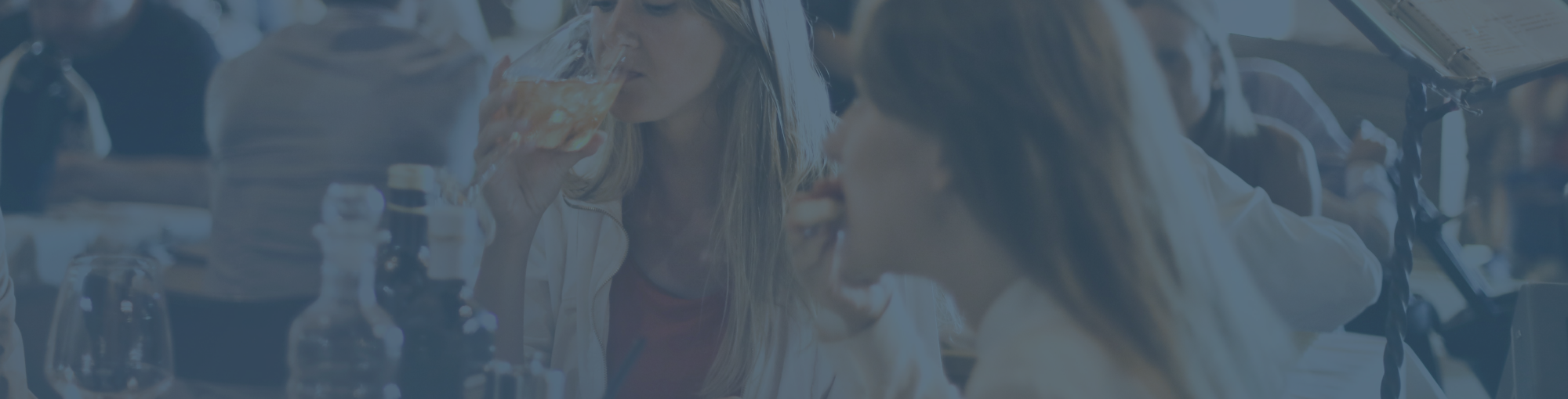 two-women-drinking-wine-and-eating-at-a-restaurant