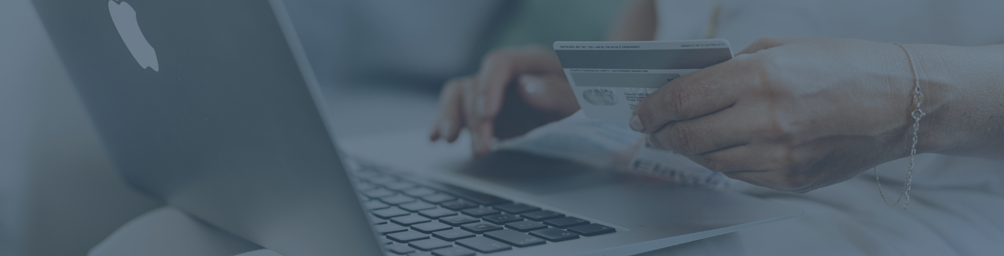 labtop-on-women-lap-while-she-looking-at-credit-card-in-left-hand